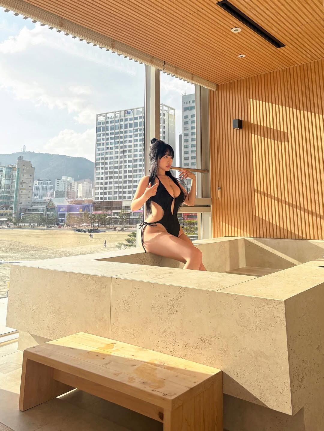 조명이 비치는 실내 스파에서 블랙 모노키니 분위기를 완성한 수진